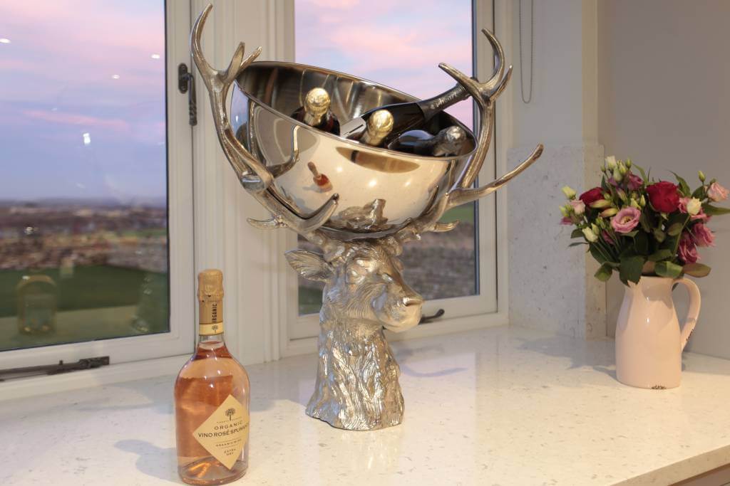 bottles of champagne in unusual stag's head ice bucket