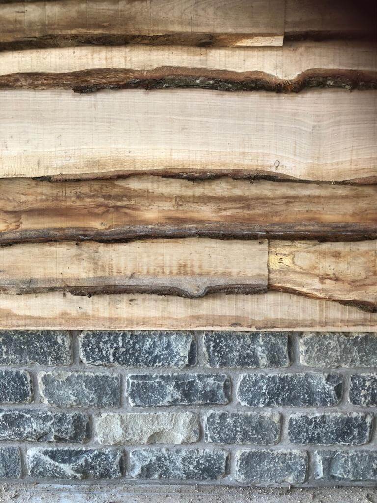 Close up of wood cladding and stone wall
