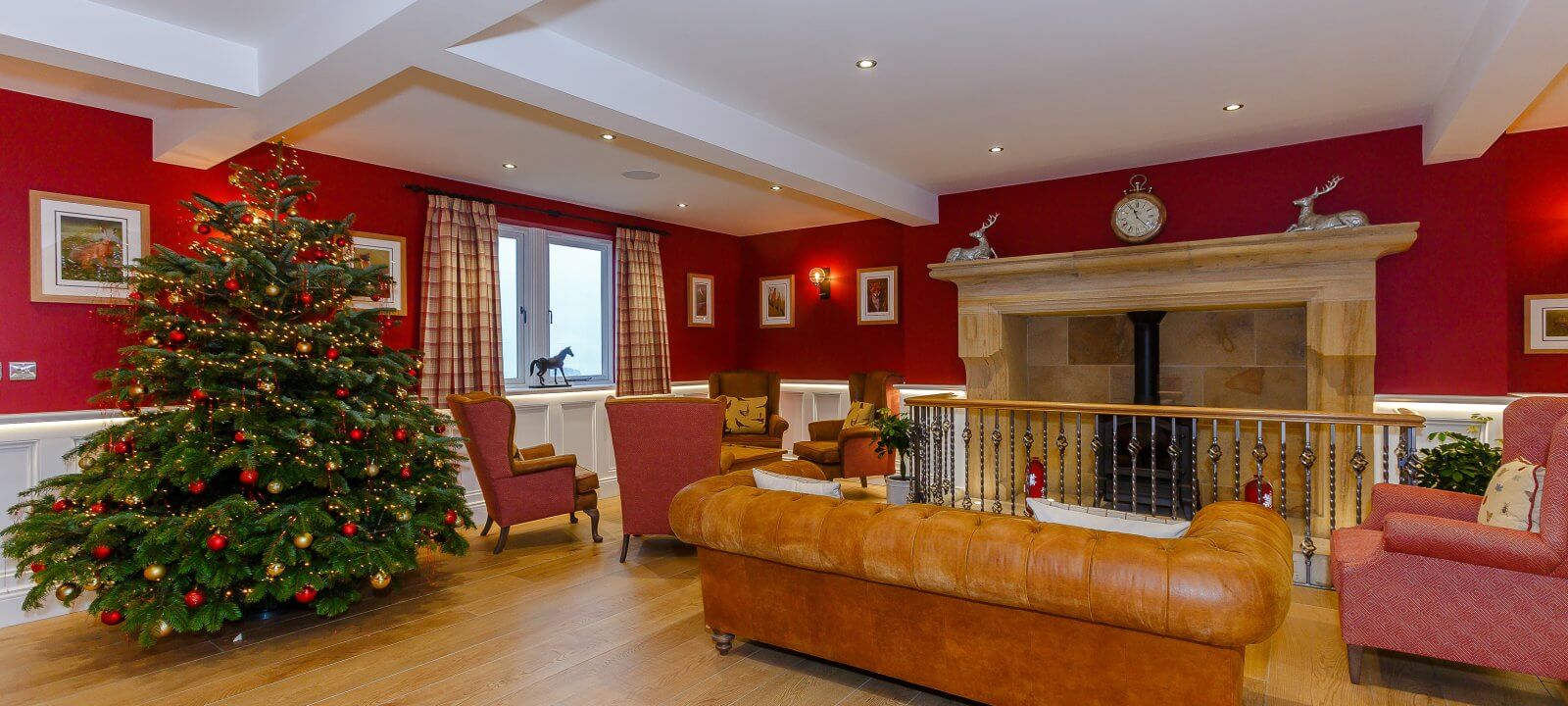 Christmas tree in hall with fireplace