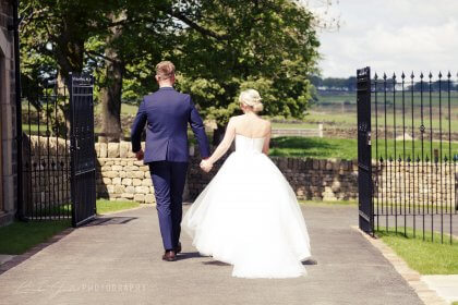 Bride and Groom outdoors, seen from behind