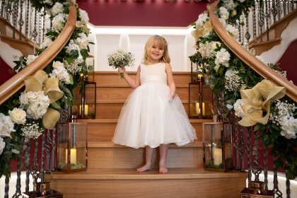 Flower girl standing on stairs