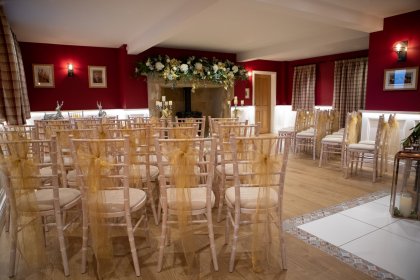 Hall with white chairs arranged for ceremony