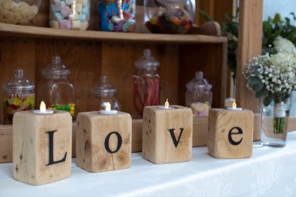 Wooden candle holders spelling out the word LOVE