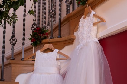 Bridesmaid dresses hanging from stairs
