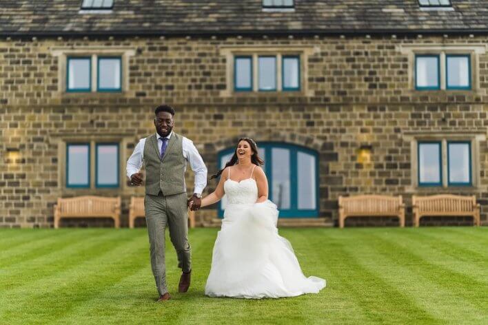 Couple in wedding outfits on lawn